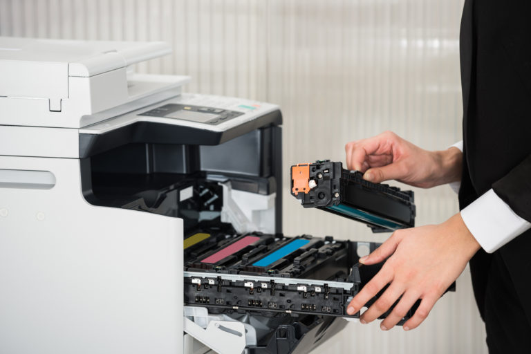 Person changing printer cartridge