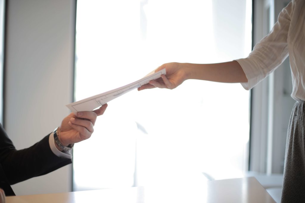 Photo of people handing over notarized documents